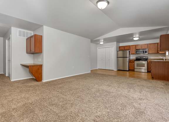 A kitchen area with a refrigerator, microwave, and oven.