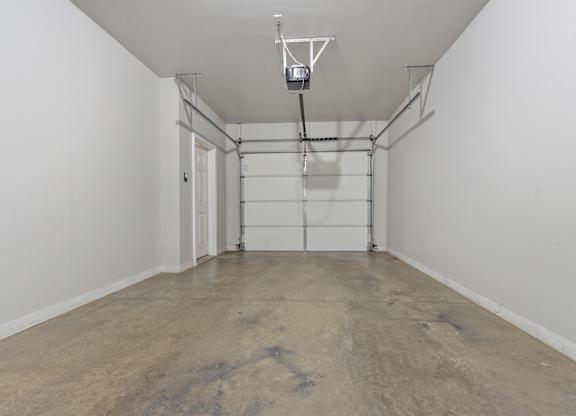 A room with a concrete floor and white walls.