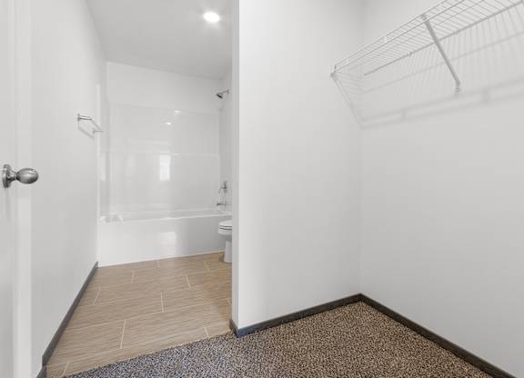 A bathroom with a toilet, sink, and shower.