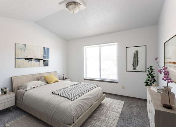 A bedroom with a bed, nightstand, and a window.