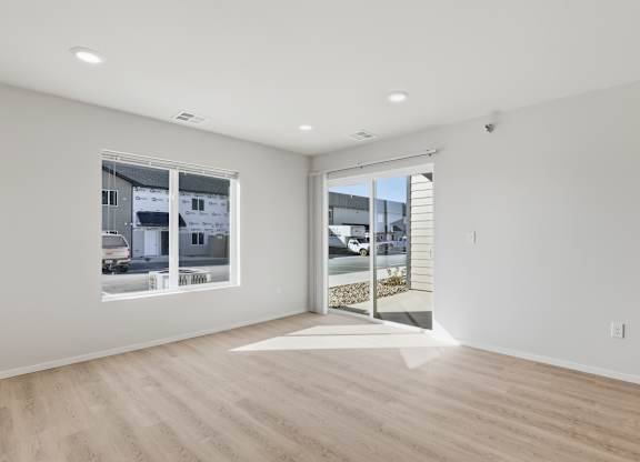 A room with a large window and a sliding glass door.
