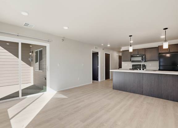 A modern kitchen with a white countertop and dark cabinets.