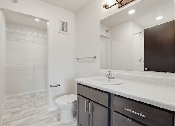 A bathroom with a white toilet and a white sink.