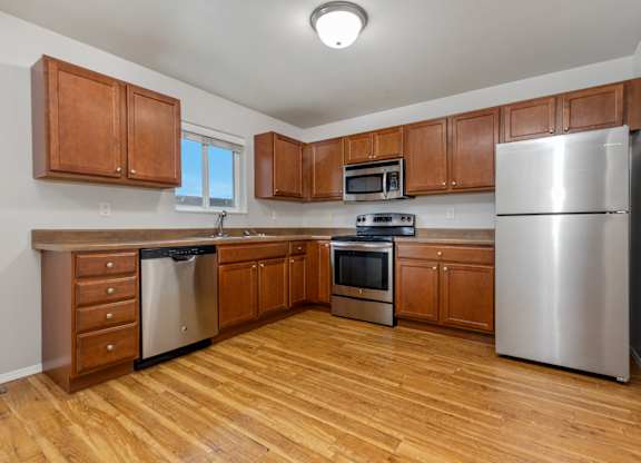 A kitchen with wooden cabinets and stainless steel appliances.