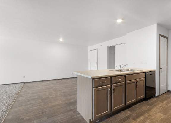 A kitchen with brown cabinets and a white countertop.