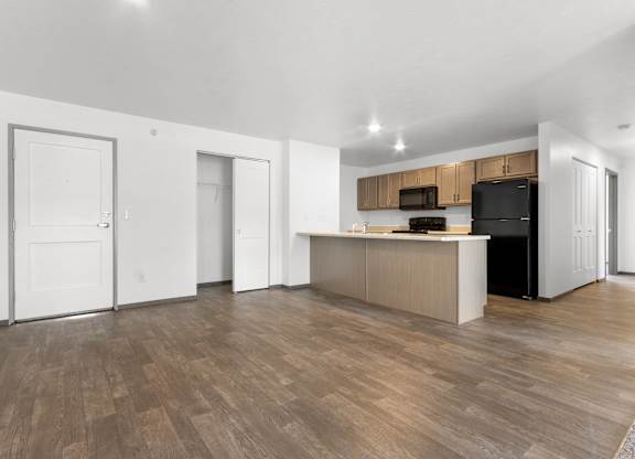A kitchen area with a counter and cabinets.