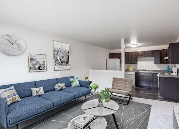 A living room with a blue couch and a coffee table.