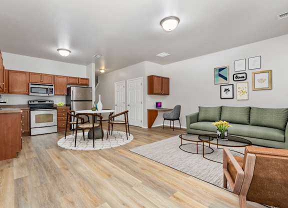 A kitchen with a dining table and chairs in the middle of the room.
