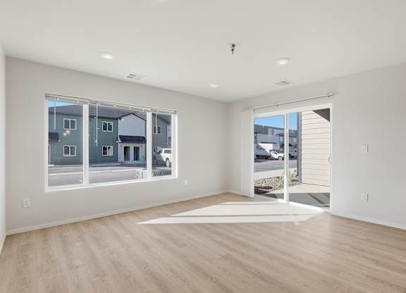 A large empty room with a view of the street outside.