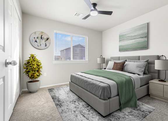 A bedroom with a bed, nightstand, and a plant.