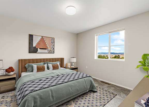 A bedroom with a bed, nightstand, and window.