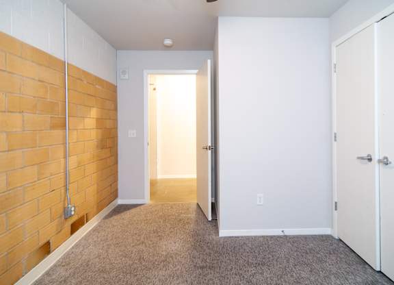 A room with a white door and a white cabinet.