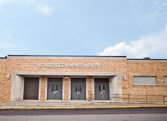 The Aberdeen Apartments is a brick building with three doors.