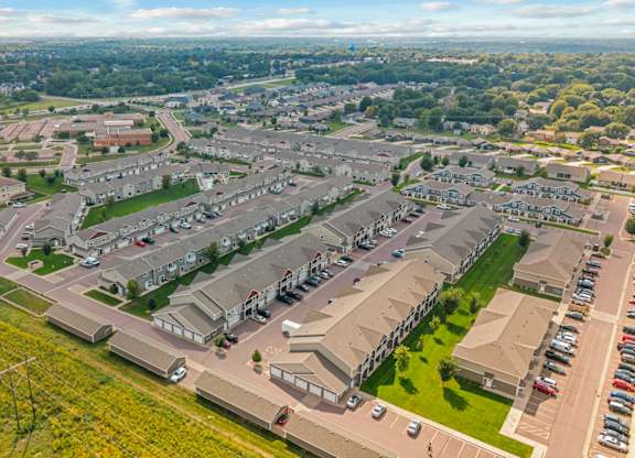 A bird's eye view of a residential area with houses and cars.