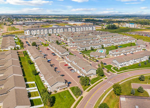 A residential area with houses and a parking lot.