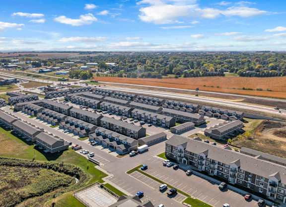 A large housing complex with multiple buildings and parking lots.