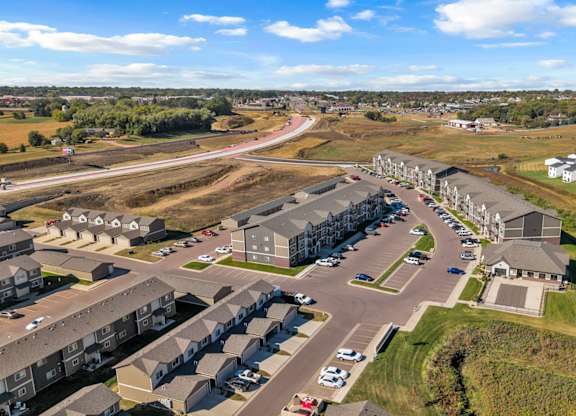 A bird's eye view of a residential area with houses and cars.
