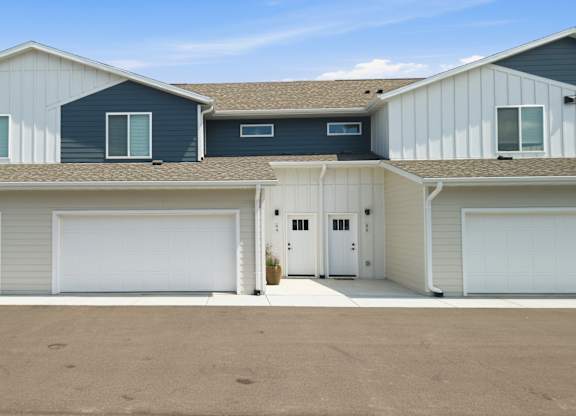 A row of garage doors in front of a building.