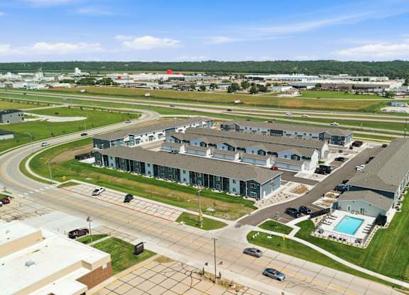 A large building complex with a pool in the foreground.
