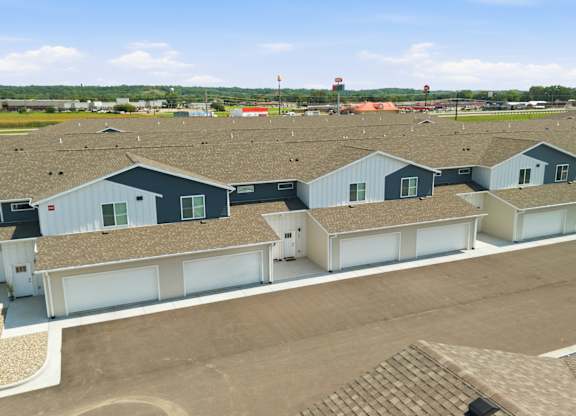 A large building complex with multiple garages and a parking lot.