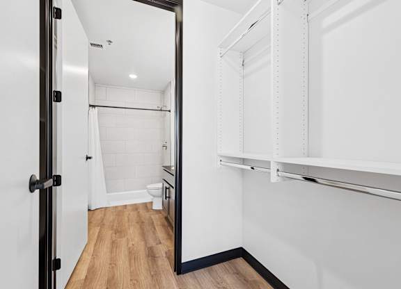 A white bathroom with a walk in shower and a toilet.