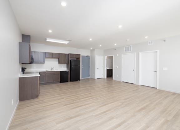 A kitchen area with a counter and cabinets.