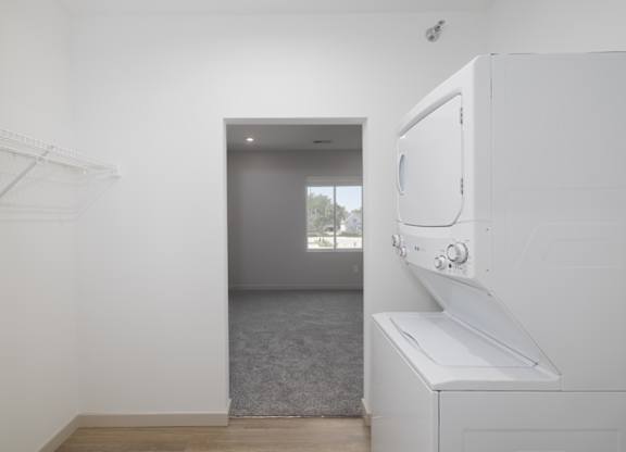 A white kitchen with a microwave and oven built into the cabinetry.