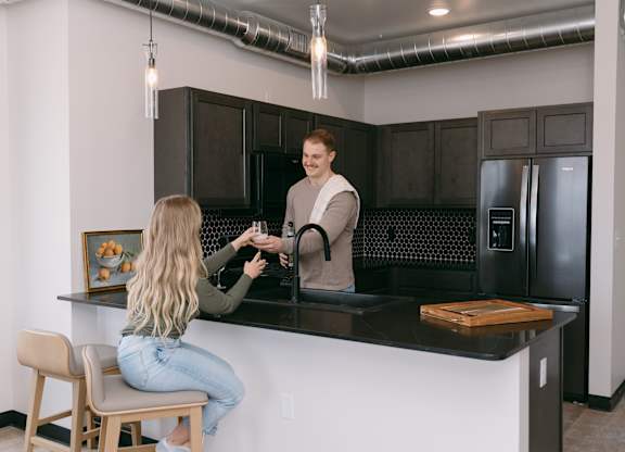 A man is serving a woman at a bar.