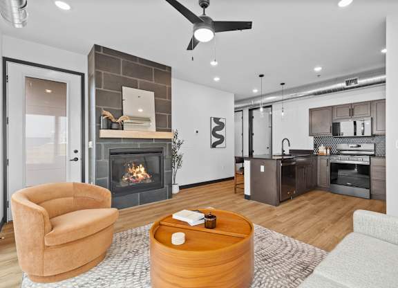 A modern living room with a fireplace and a brown armchair.