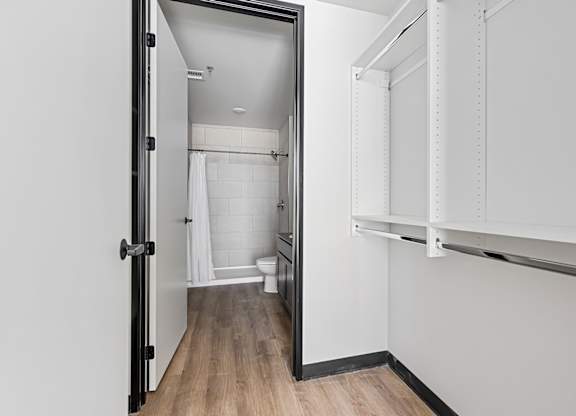 A white bathroom with a toilet, sink, and shower.