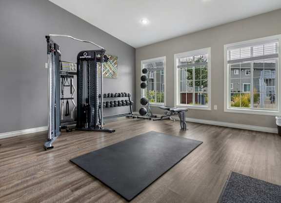 A spacious home gym with a variety of equipment.