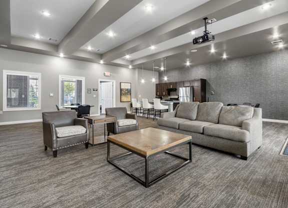 A spacious living room with a grey sofa, a wooden coffee table, and a television.