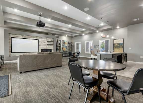 A modern living room with a grey sofa, a black coffee table, and a television.
