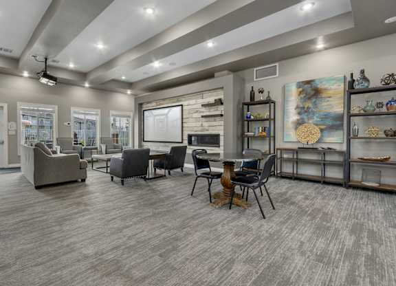 A modern living room with grey flooring and furniture.