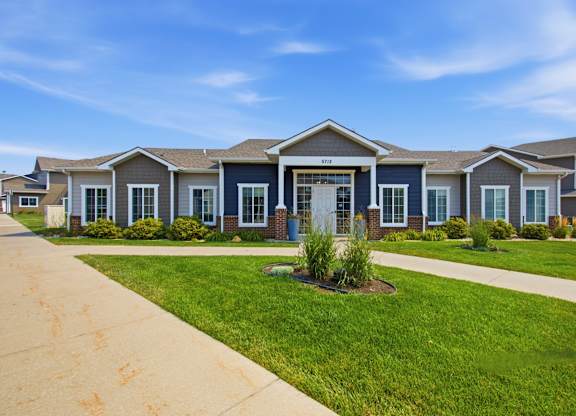 A row of houses with a blue sky above them.