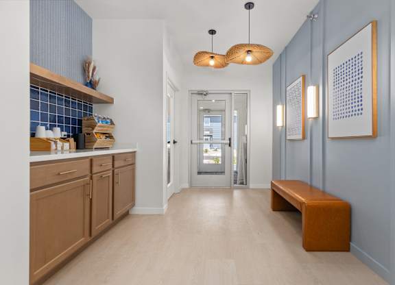 A hallway with a bench and pictures on the wall.