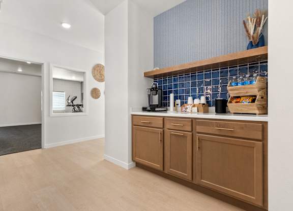 A kitchen with brown cabinets and a blue tile backsplash.