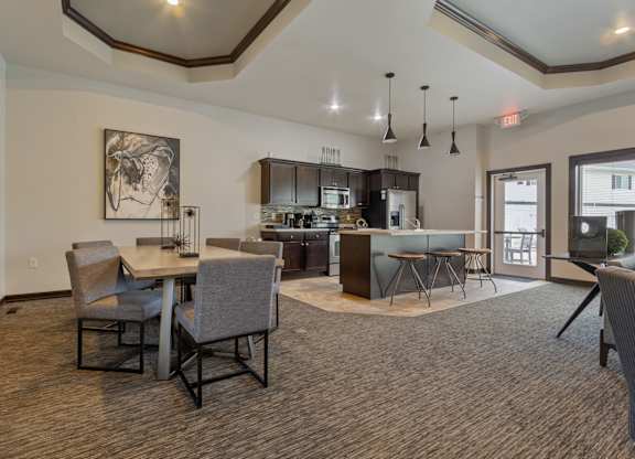 A modern kitchen with a dining table and chairs.