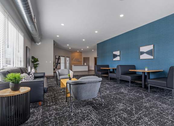 A modern waiting room with grey and blue accents.