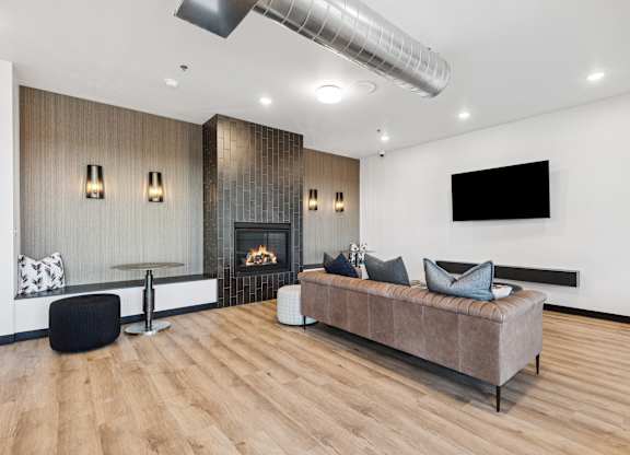 A modern living room with a fireplace and a large couch.