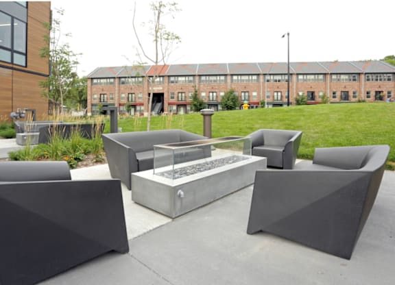 Outdoor kitchen area with barbecue and dining table.