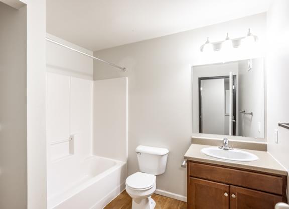 a bathroom with a sink toilet and a bath tub