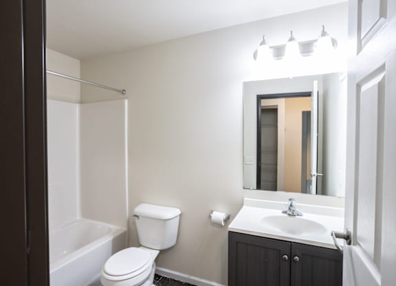 a bathroom with a sink toilet and a mirror