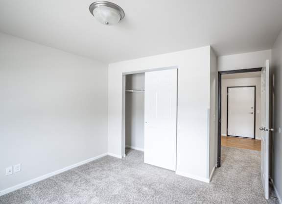 a bedroom with a closet and a door to a closet