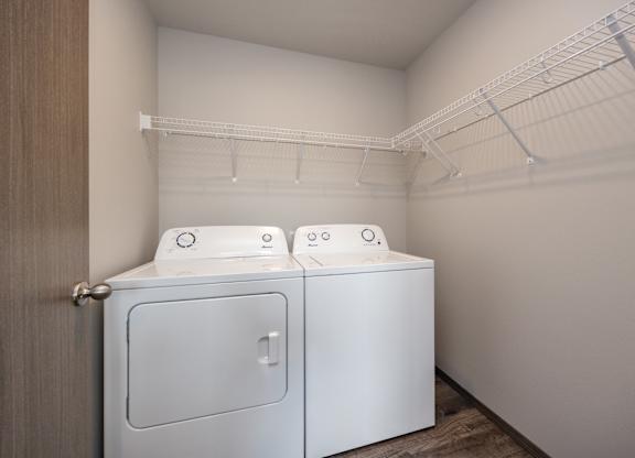 Two washing machines in a small laundry room.