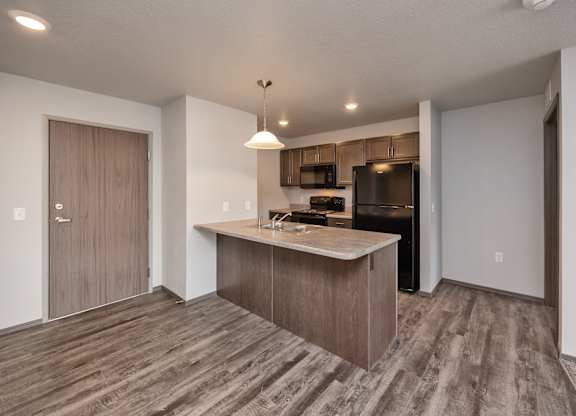 A kitchen with a wooden floor and a countertop.