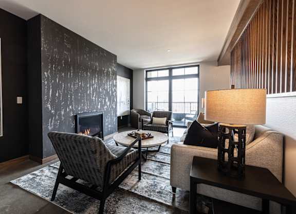 A living room with a fireplace and a chair.
