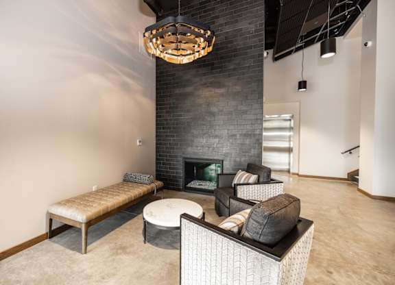 A modern living room with a fireplace and a chandelier.