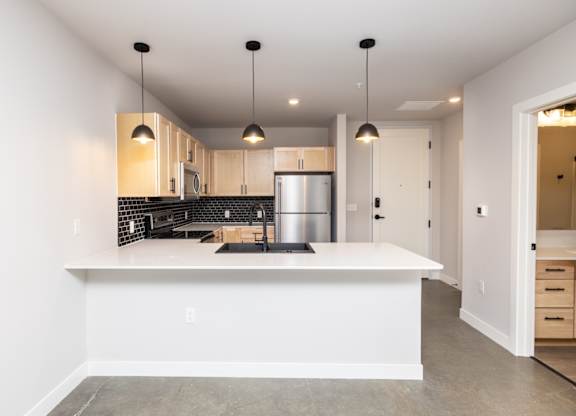 A modern kitchen with a large island in the middle.