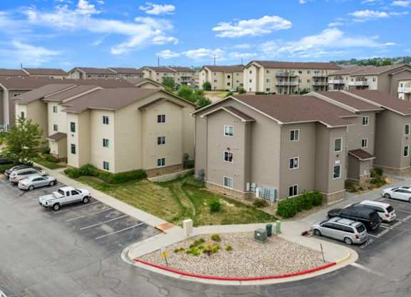A parking lot in front of apartment buildings.